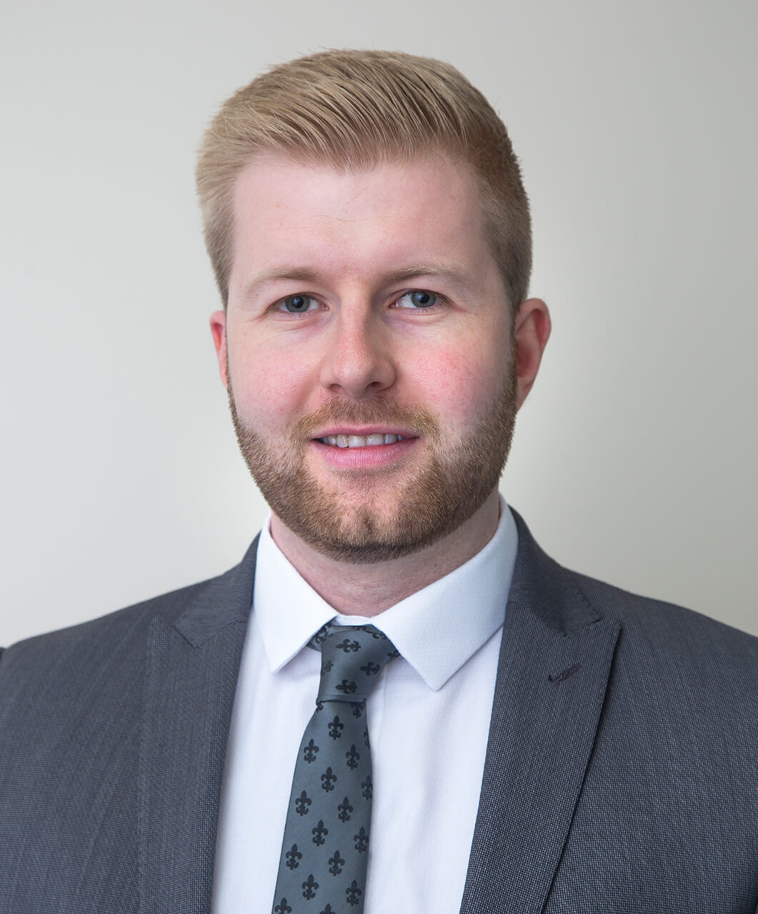 A picture of a well groomed man wearing a suit