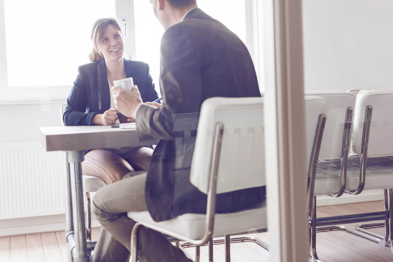 man and woman in office talking
